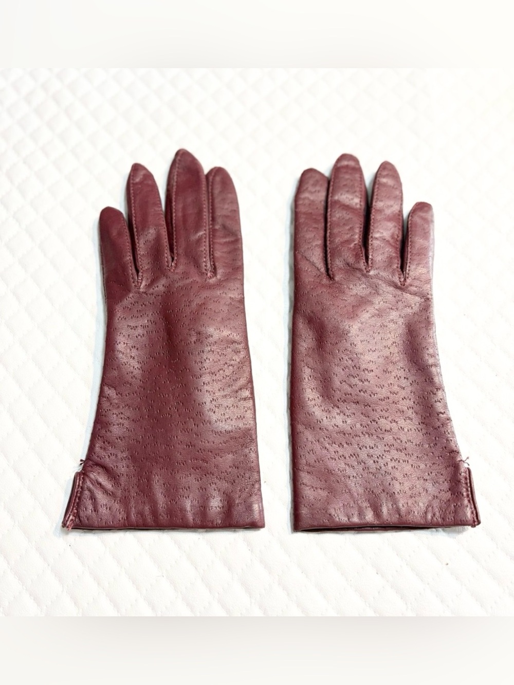 maroon leather gloves feature a distinctive textured perforated pattern 6.5
